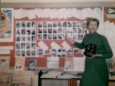 Jerry with wall of soldier photos and plaque from platoon 1969